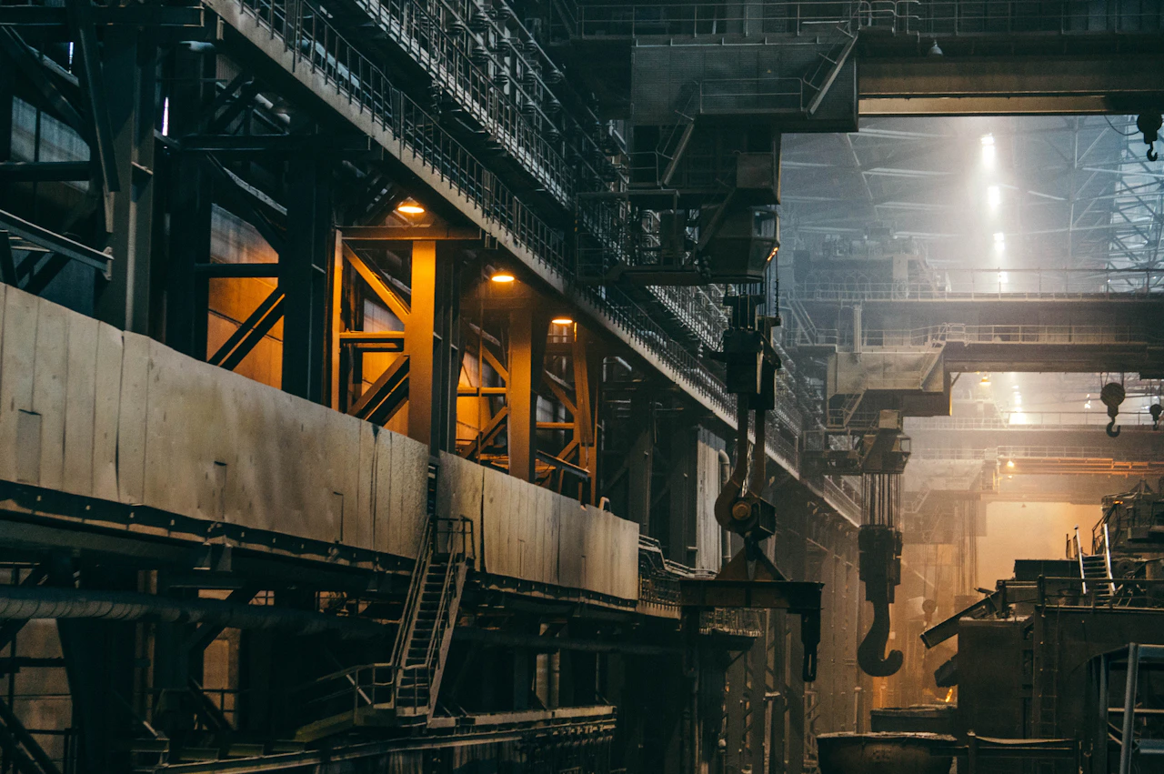 Machinery and overhead cranes inside a working steel factory